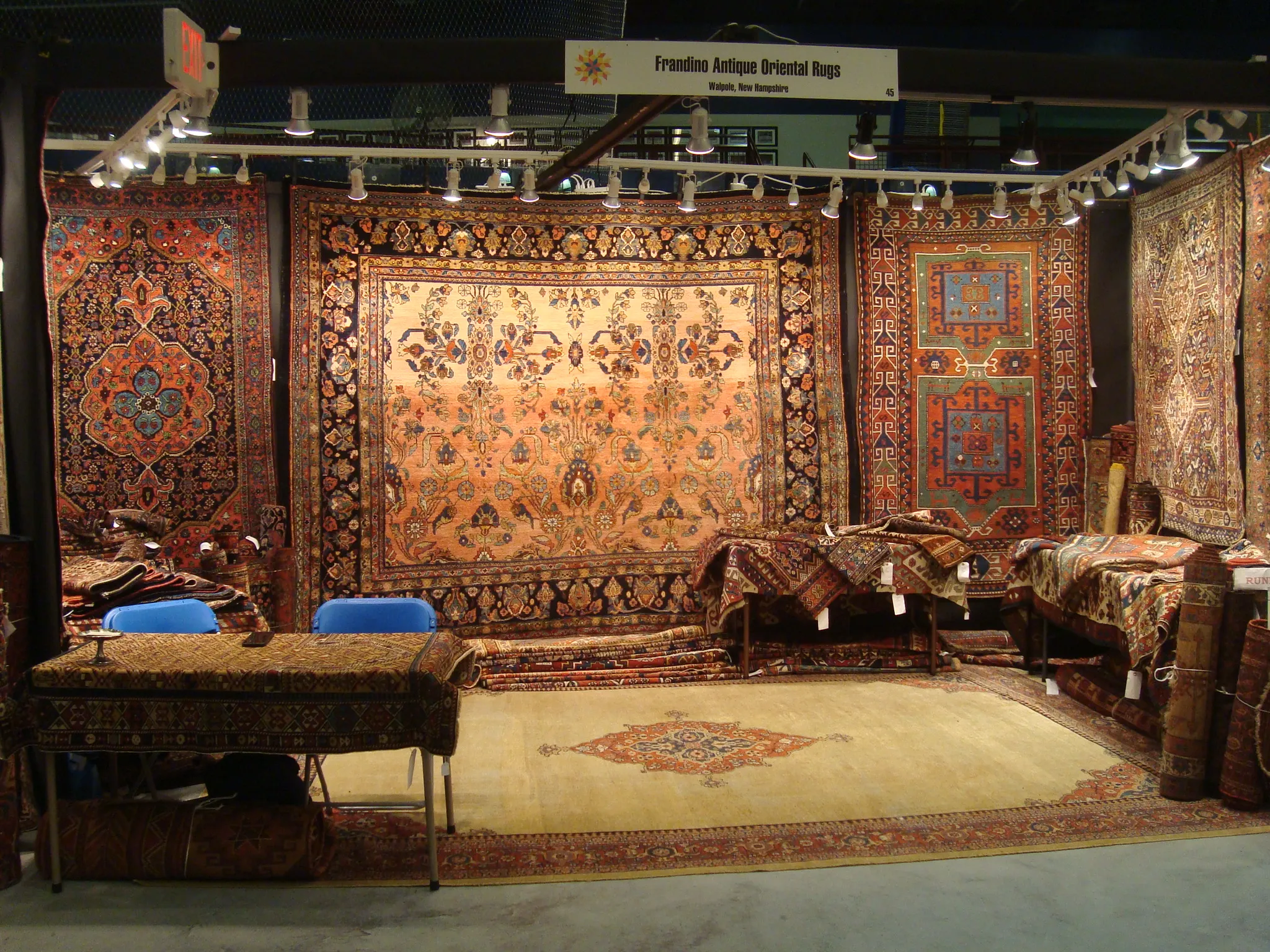 Antique Persian carpet with intricate floral patterns and rich burgundy colors