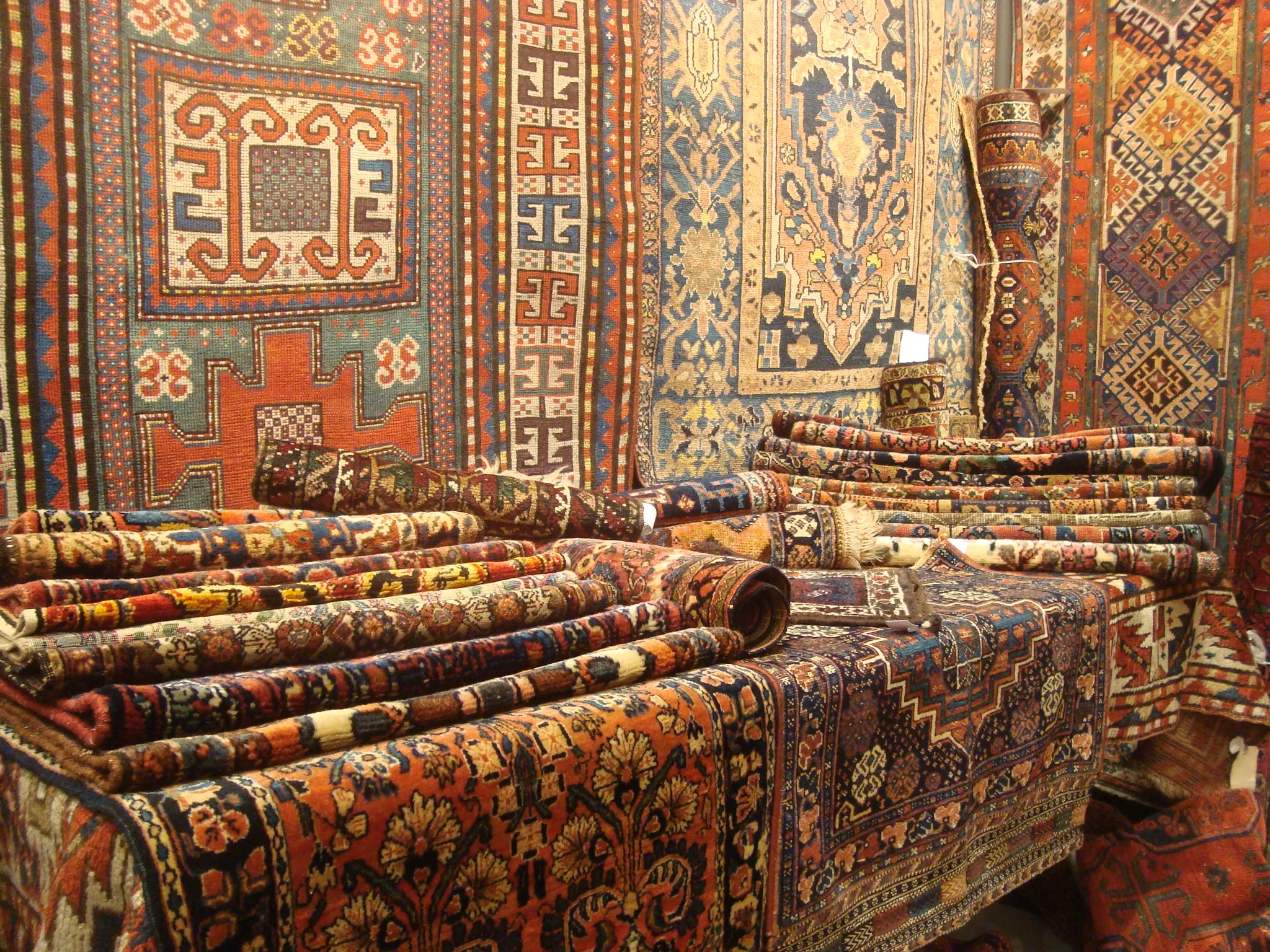 Traditional Caucasian rug featuring geometric medallion design in earth tones